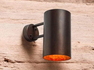 Oxidized black-patina copper wall sconce for outdoor use - modern cylindrical wall sconce with dark bronze exterior finish - copper sconce